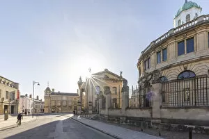 Images Dated 24th March 2021: Cyclist beside the Sheldonian Theatre, Oxford, Oxfordshire, England, UK