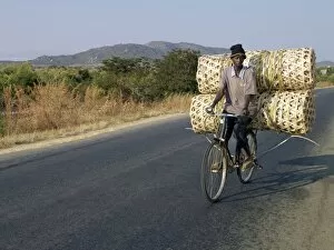 Images Dated 22nd July 2006: A cyclist taking baskets to market