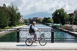 Cycling Prints: Cyclist on traditional bridge, Struga, North Macedonia