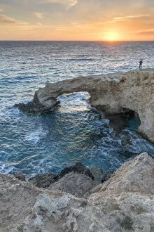 Agia Napa Gallery: Cyprus, Ayia Napa, Cape Greco, man at sunset standing over the Love Bridge
