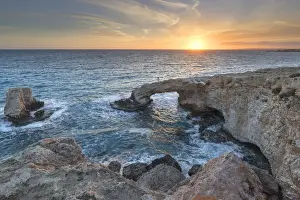 Cyprus, Ayia Napa, Cape Greco, woman whit a white dress at sunset standing over