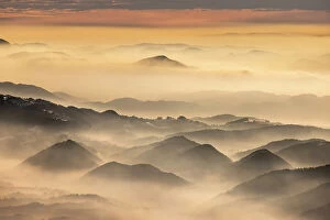Images Dated 26th June 2023: Dawn over the foothills of the Kamnik Savinja Alps from Kravavec, Slovenia