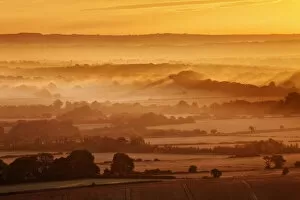 Dawn mist and rolling chalk downland viewed from Wilmington Hill, Willmington