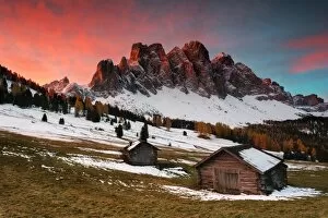 Grass Collection: Dawn on the Odle with typical huts. Puez-Odle Natural Park, Trentino Alto Adige, Italy