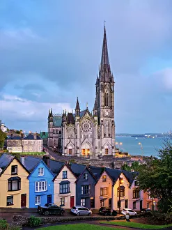 Deck of Cards colourful houses and St. Colman's Cathedral at dusk, elevated view, Cobh, County Cork, Ireland