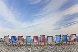 Blue Sky Gallery: Deckchairs on pebble beach, Sidmouth, Devon, UK