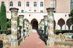 Catholicism Prints: Decorated colonnade with majolica tiles in the cloister entrance of Santa Chiara monastery