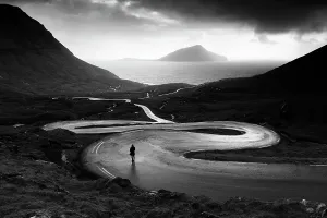Foroyar Prints: Denmark, Faroe Islands, Foroyar, Streymoy, one person stands on a twisting road