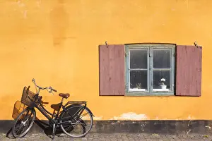 Kobenhavn Prints: Denmark, Zealand, Copenhagen, yellow building detail with bicycle