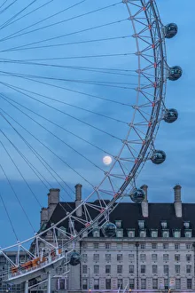 Images Dated 14th August 2019: Details of London Eye ferris wheel with County Hall in background under the full moon
