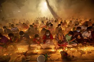 Crowd Prints: Devotees attend prayer with burning incense and light oil lamps before break fasting