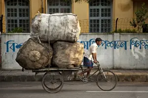 Goods Prints: Dhaka, Bangladesh. A rickshaw rider transports goods around the capital