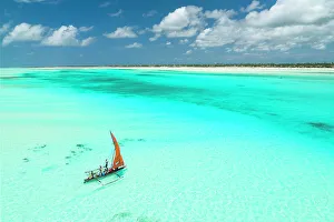 February Gallery: a Dhow plows through the sea of the lagoon, Zanzibar, Tanzania