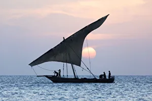 Dhow Prints: A dhow sails in front of the setting sun, Stone Tpwn, Zanzibar, Tanzania