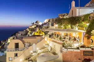 Dining experience at dusk in Oia, Santorini, Cyclades Islands, Greece
