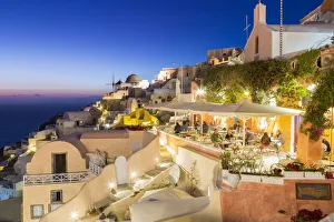 Mediterranean Area Prints: Dining experience at dusk in Oia, Santorini, Cyclades Islands, Greece