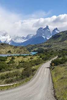 Dirt road and Lake Pehoa and Paine Horns in the background, in summer