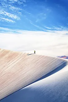 Walk Prints: DIstant hiker walking on pumice dunes