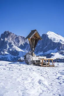 Bench Prints: Dolomites Alps, snow landscape with clear blue sky. pic nic bench, mountains in background