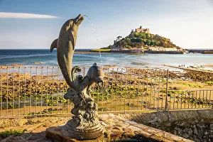 Dolphin Prints: Dolphin statue overlooking St Michael`s Mount, Marazion, Cornwall, England