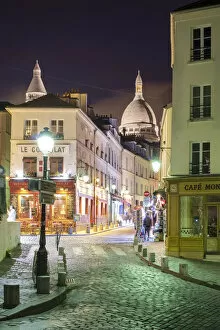Dome of SacrAA -Coeur Basilica over buildings in Montmartre at night, Paris, AA┬Äle-de-France