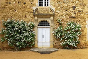 Hedge Prints: The front door of Eyrignac manor house surrounded by flowers