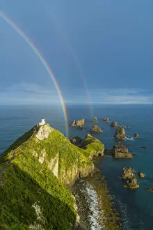 Ahuriri Flat Gallery: Double rainbow over Nugget Point lighthouse after the storm