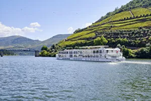Images Dated 10th November 2020: A Douro river cruise ship passing along the village of Pinhao