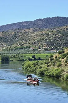The Douro river and a tour boat at Pocinho, a Unesco World Heritage Site. Portugal