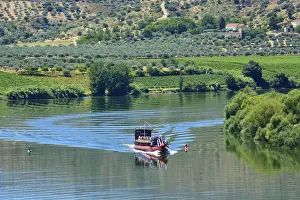 The Douro river and a tour boat at Pocinho, a Unesco World Heritage Site. Portugal