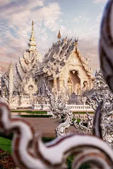 Building Exterior Prints: Dragons statues framing the Wat Rong Khun or White Temple buddhist landmark at dawn