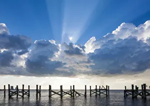 Empty Gallery: Dramatic clouds and sunbeams over a blue sky. Lake Pontchartrain, New Orleans, Louisiana
