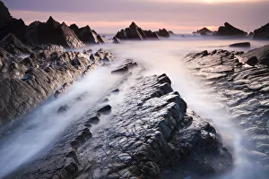 Dramatic coastal scenery at sunset, Hartland Quay, Devon, England. Spring (April) 2010