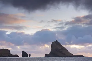 April Prints: Dramatic outline of Tindhaolmur island at sunset, Vaagar, Faroe Islands, Denmark, Europe