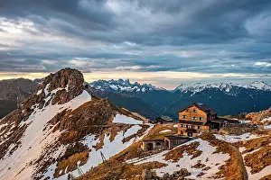 Trentino Prints: Dramatic sky with clouds at dawn over Roda di Vael hut on mountain top
