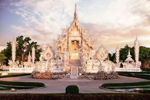 Building Exterior Prints: Dramatic sky at dawn over the surreal Wat Rong Khun (White Temple) buddhist landmark