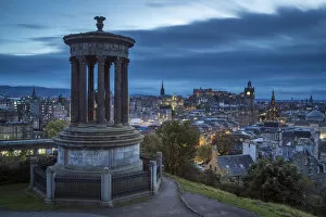 Dugald Stewart Monument and illuminated Edinburgh city viewed from Observatory House