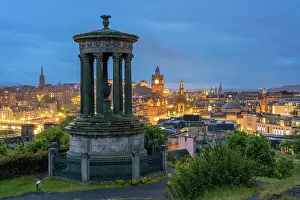 Dugald Stewart Monument and illuminated Edinburgh city viewed from Observatory House at twilight, UNESCO, Calton Hill, Edinburgh, Scotland, United Kingdom