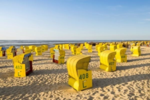 Duhnen, Cuxhaven, Lower Saxony, Germany. Yellow Strandkorbs along the Wadden Sea