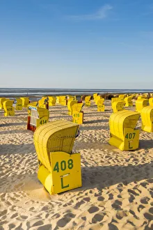 Duhnen, Cuxhaven, Lower Saxony, Germany. Yellow Strandkorbs along the Wadden Sea