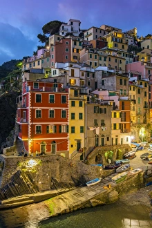 Dusk view of the colorful sea village of Riomaggiore, Cinque Terre, Liguria, Italy