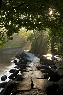 Images Dated 22nd January 2015: Early morning sunlight shining onto Tarr Steps ancient clapper bridge, Exmoor National