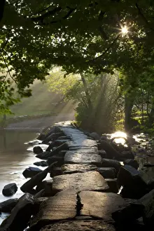 Somerset Prints: Early morning sunlight shining onto Tarr Steps ancient clapper bridge, Exmoor National