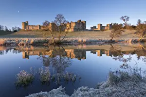 Northumberland Prints: Early morning sunshine illuminates Alnwick Castle in Northumberland, England. Winter