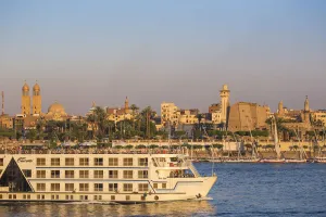 River Nile Prints: Egypt, Luxor, Nile cruise boat passing intont of Luxor temple