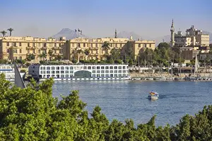 Winter Palace Prints: Egypt, Luxor, View of Nile cruise boats infront of The Winter Palace Hotel