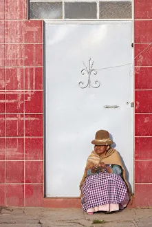Ethnic Gallery: Elder woman sitted in front of a door in Copacabana, Lake Titicaca, La Paz, Bolivia