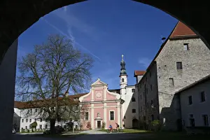 Bicycles Prints: Electric cyclists before the church of St. Michael in the castle Tittmoning, Chiemgau