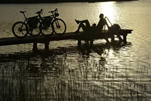 Bikes Collection: Electric cyclists on jetty, Klostersee Castle Seeon, Chiemgau, Upper Bavaria, Bavaria
