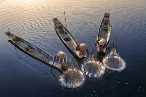 Images Dated 23rd April 2020: Elevated view of three fishermen catching fish from boats using traditional conical nets